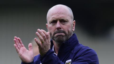 Mark Bowen claps towards fans during his time at AFC Wimbledon