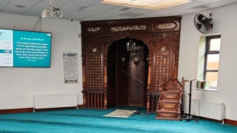 Prayer area with a blue prayer mat 