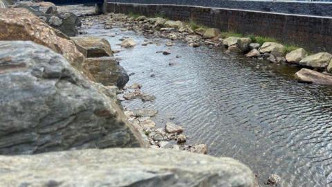 The river in Laxey with flood defences on each side