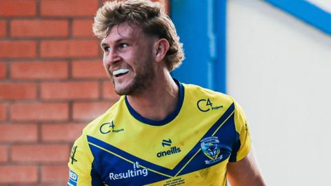 Alfie Johnson celebrates scoring a try for Warrington Wolves on his Super League debut in March 2025