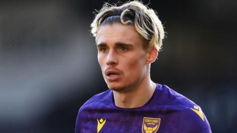 Oxford United winger Przemyslaw Placheta in action for the club, wearing their purple kit