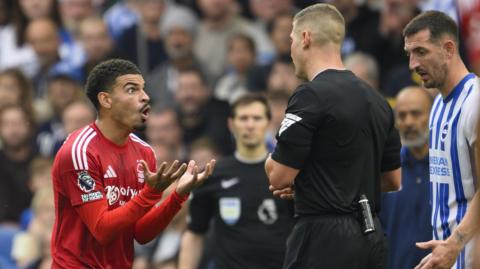 Morgan Gibbs-White stretches out his hands to plead with referee Rob Jones after he was sent off against Brighton. 