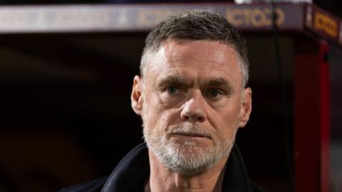 graham alexander has a concerned expression on his face.