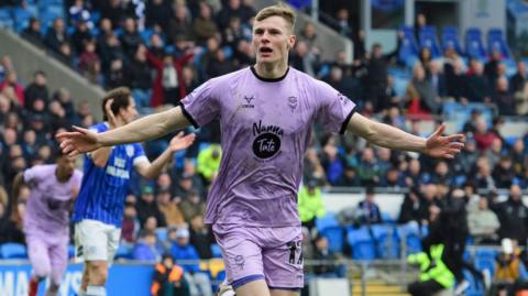 Rob Street celebrates his goal for Lincoln