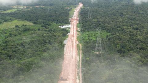 Partially built highway cuts through the rainforest, image taken from drone