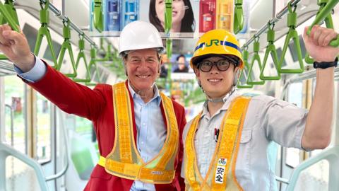 Michael Portillo, Mr Yuto Kondo
in the train carriage of Yamanote line.