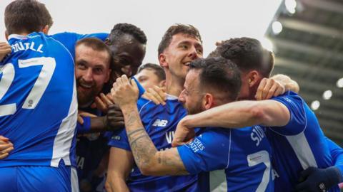 Cardiff City players celebrate scoring against Ipswich in March