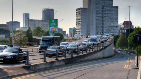 Mancunian Way in Manchester is busy with traffic.