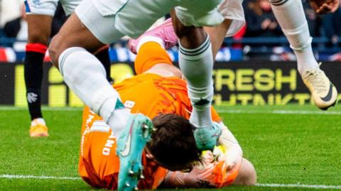 Celtic's Auston Trusty challenges Rangers' Jack Butland