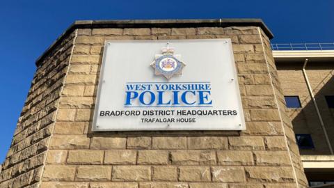 A sign spelling out West Yorkshire Police and Bradford District Headquarters, Trafalgar House.