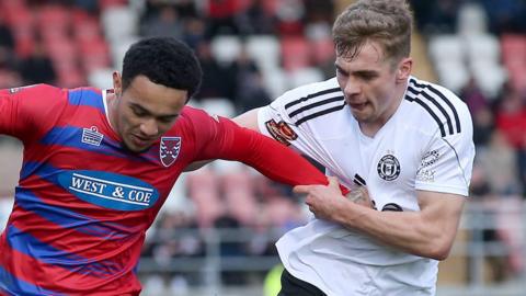 Jack Evans (right) challenges for the ball