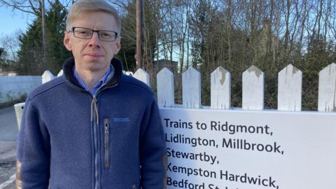 John Baker standing by a railway line