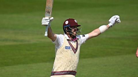 Craig Overton with both arms aloft in celebration