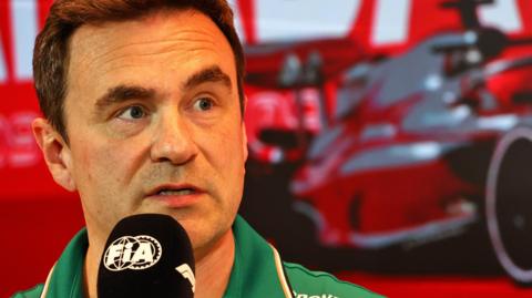 Dan Fallows speaking into an FIA-branded microphone