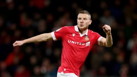 Paul Mullin runs into space for Wrexham while keeping his eye on the ball