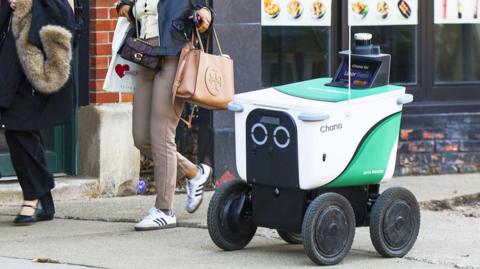 A delivery robot on a sidewalk in Chicago