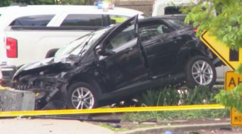 A black car that has been damaged in the attack, with police caution tape nearby