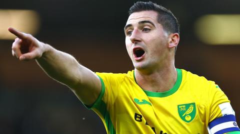 Kenny McLean points his right index finger during a game for Norwich City last season