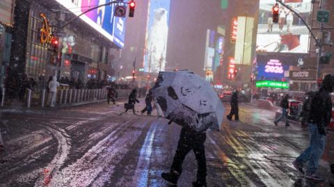 A person crosses the street during the winter blizzard in New York, New York, USA, 22 February 2026. The National Weather Service has issued a blizzard warning for New York City, forecasting up to 24 inches of snow. 