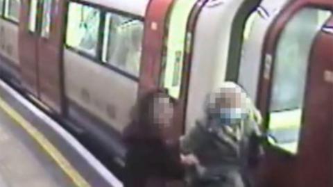 A London Underground passenger caught their coat in the tube door, on the platform at Archway station facing the front of the train