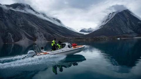 Scientists in a boat in an East Greenland fjord