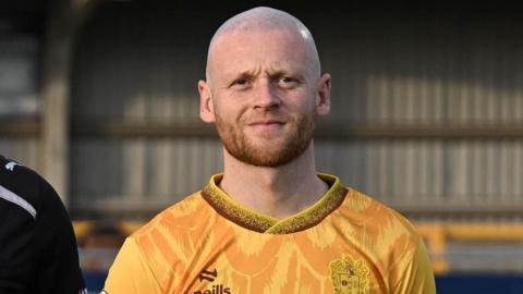 Jake Taylor, wearing a yellow Sutton United shirt, pictured before the national League game against Forest Green Rovers