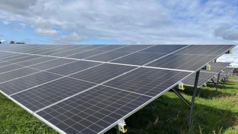 Solar panels in a field of grass