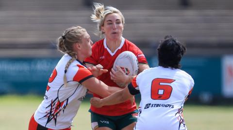 Bethan Dainton carries the ball into contact for Wales rugby league against Canada