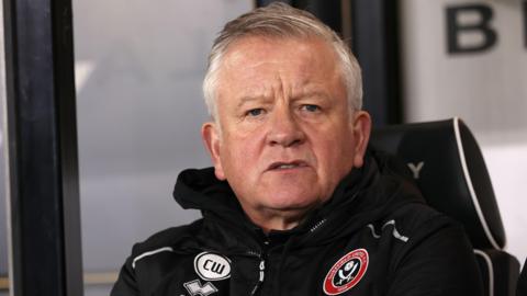 Sheffield United's Chris Wilder in a black club coat with the Sheffield United badge on it