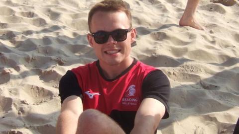 Cian Everett sat on a beach.