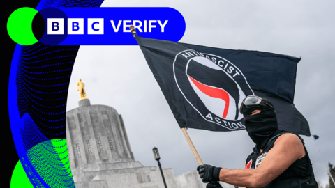 An anti-fascist protester waves a flag at a demonstration in Salem, Oregon, in 2021