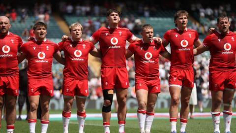 Wales players line up for the anthem against Barbarians 