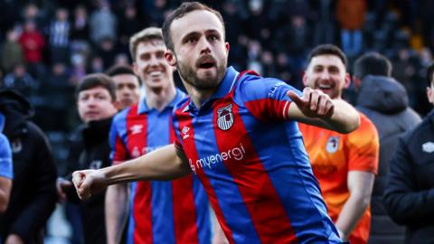 Charles Vernam celebrates with Grimsby Town fans