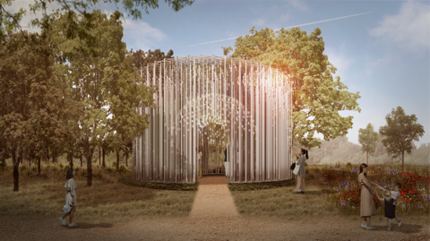 A computer-generated image showing a memorial made up of spirals of thin metal columns. A path leads up to a doorway and people can be seen inside and around the memorial. It is set in the middle of a field with trees around it.