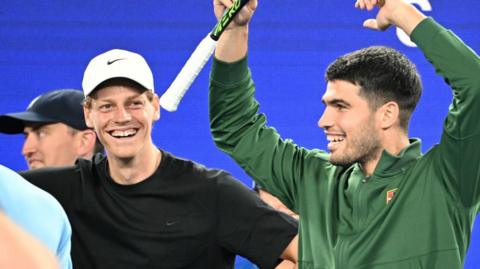 Jannik Sinner and Carlos Alcaraz laugh during the Australian Open's One Point Slam event