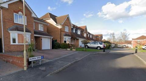 A view of Burkal Drive in Andover on a sunny day. There is no one on the street.