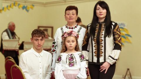 Family portrait featuring Liudmyla Zhyhunova, her mother Olha Pidhorodetska and her two children Vladyslav and Yeva.