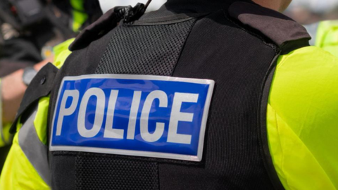 A generic picture of the back of a police officer's jacket, with "police" written on the back.