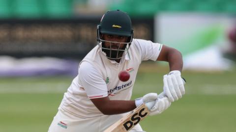 Rehan Ahmed playing for Leicestershire and carefully watching the ball