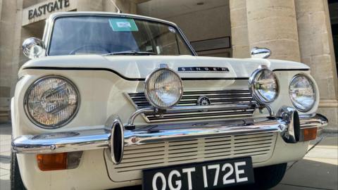 A white vintage car outside Eastgate Shopping Centre