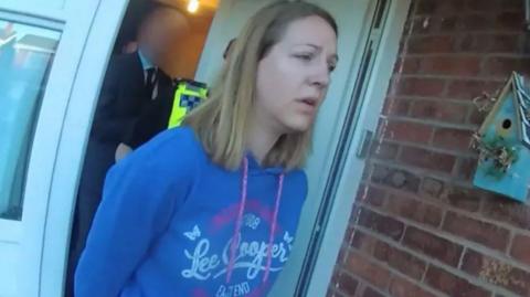 Lucy Letby leaving her home in handcuffs after her arrest 