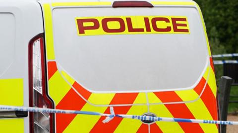 Generic image of police van and tape