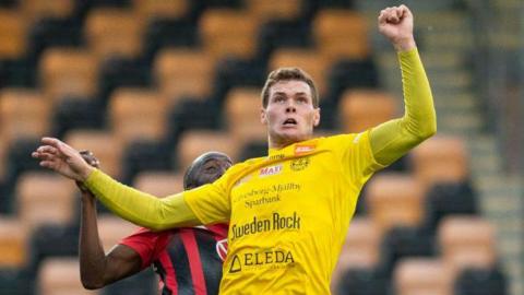 Mjallby's Jacob Bergstrom jumps for a header against Ostersunds FK in November 2020 