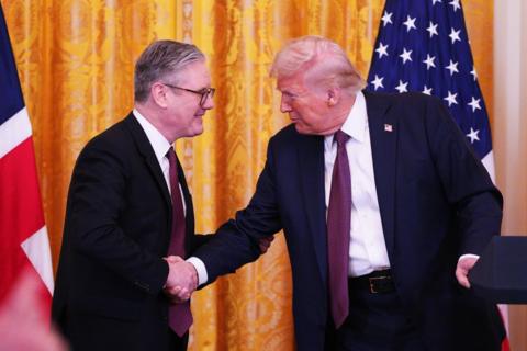 UK Prime Minister Sir Keir Starmer and US President Donald Trump shake hands in front of their flags