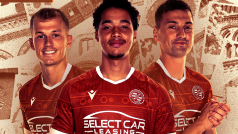 Reading players wearing the new kit in front of a collage background made up of images of the town hall.