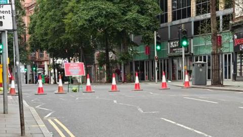 A line of cones across a usually busy city centre street