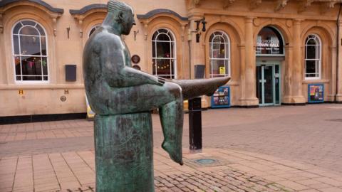 The bronze Sock man statue outside Loughborough Town Hall