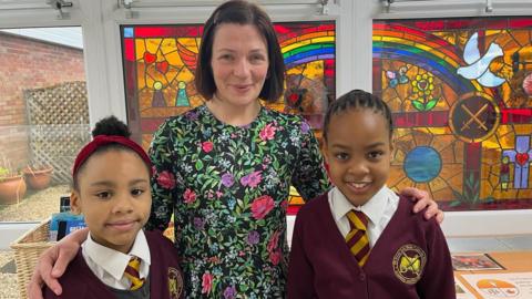 Head teacher Mrs Byrne with two pupils 