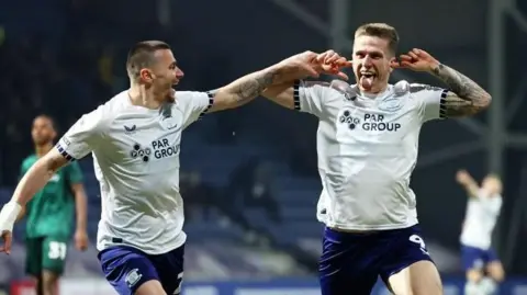 Preston North End striker Emil Riis (right) celebrates his equalising goal against Millwall while being congratulated by Milutin Osmajic