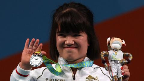 Olivia Broome holds up her silver medal during the 2022 Commonwealth Games